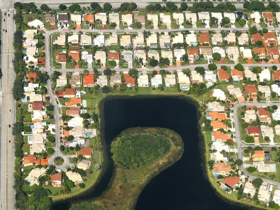Aerial view of a Kendall subdivision in Miami-Dade, with rows of tile-roof houses around a lake