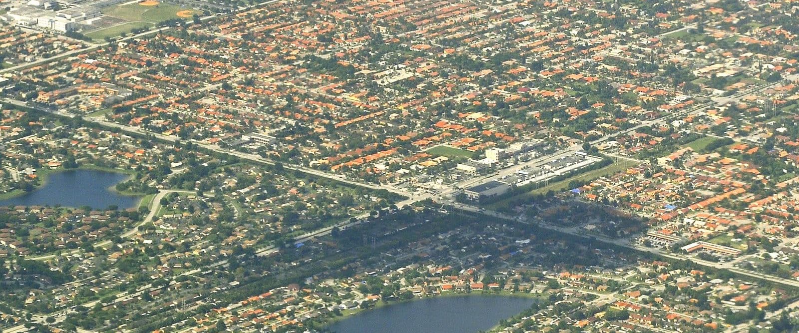 Aerial view of Miami-Dade suburbs, thousands of houses with two lakes and a shopping strip